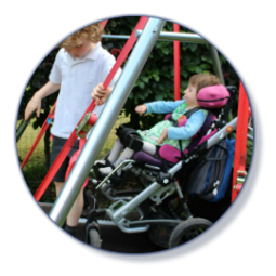 Willow and Arthur playing on the wheelchair swing